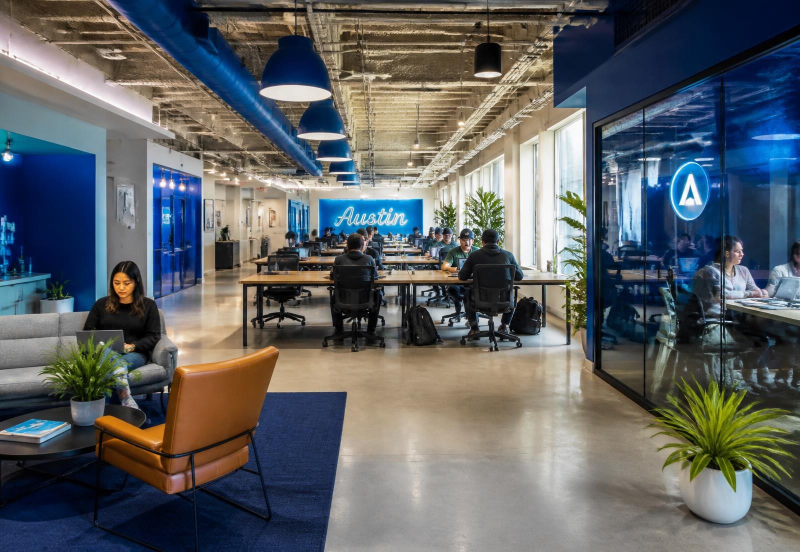 Members working in a modern coworking space with meeting rooms